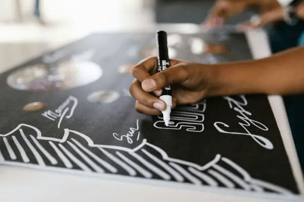 A child using water soluble marker on paper